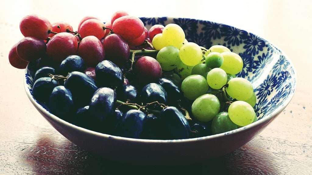 An image of grapes in a bowl