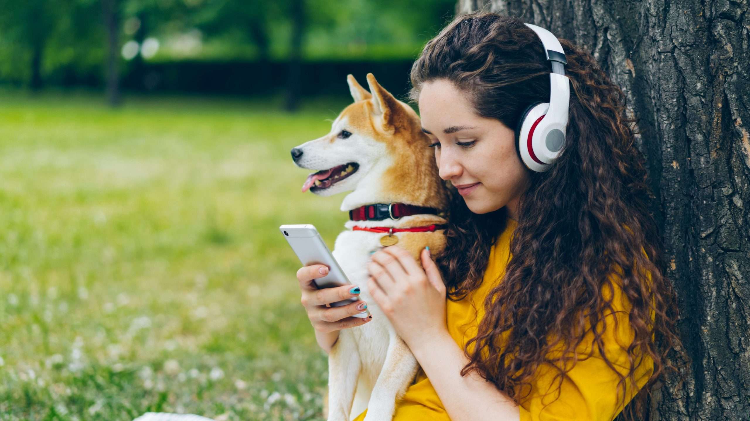 An image of a dog listening to music with its owner - music on pets